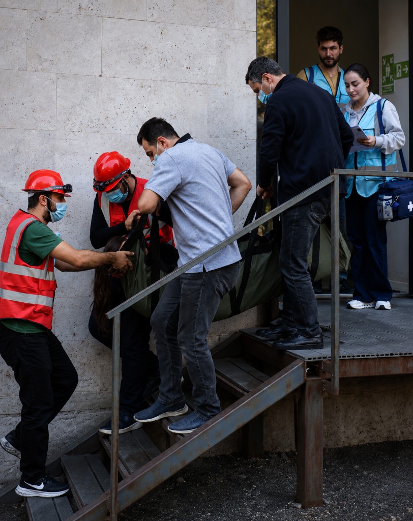 Team carrying a person on a stretcher down stairs during an evacuation drill